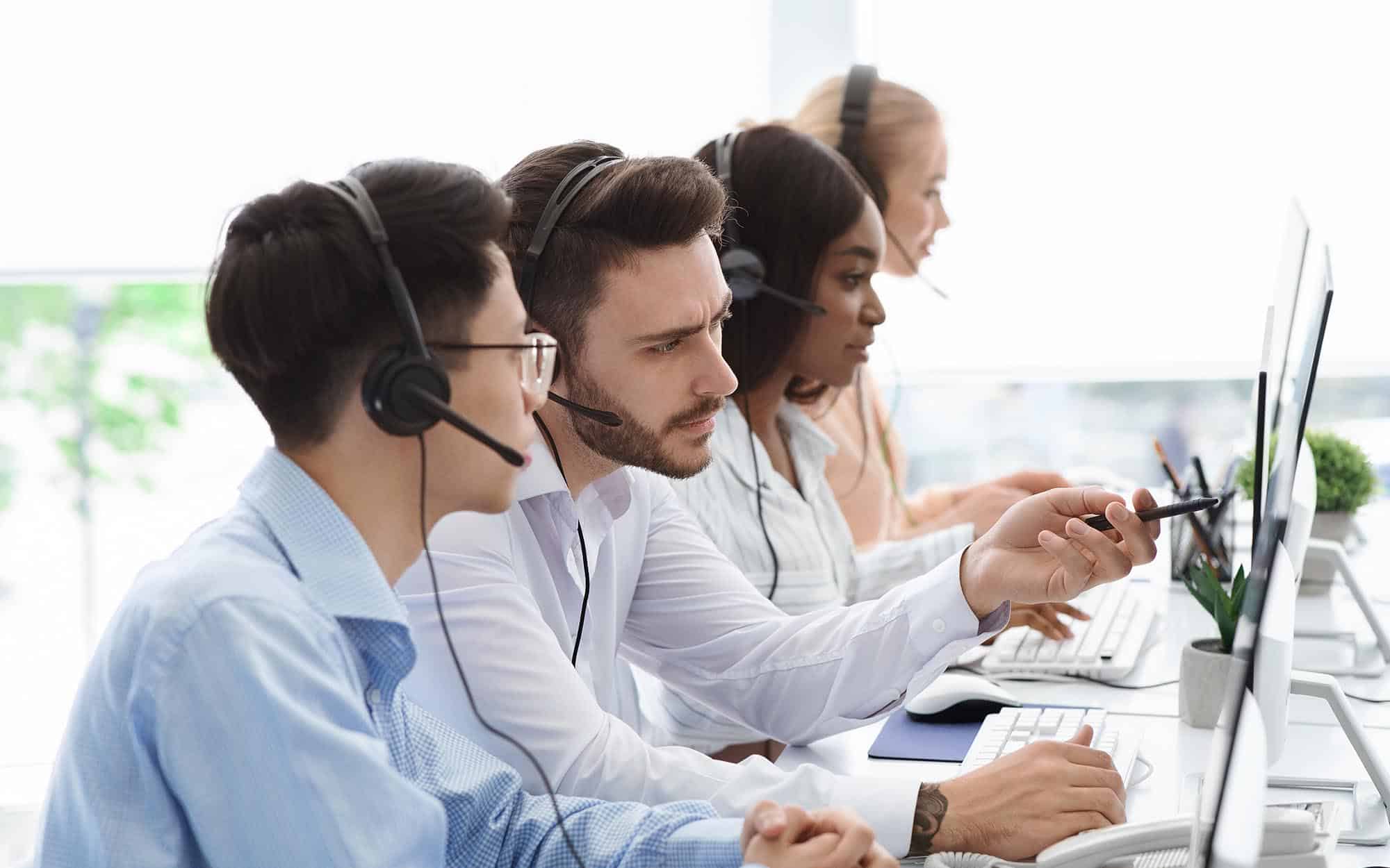Call center professionals looking at computers.