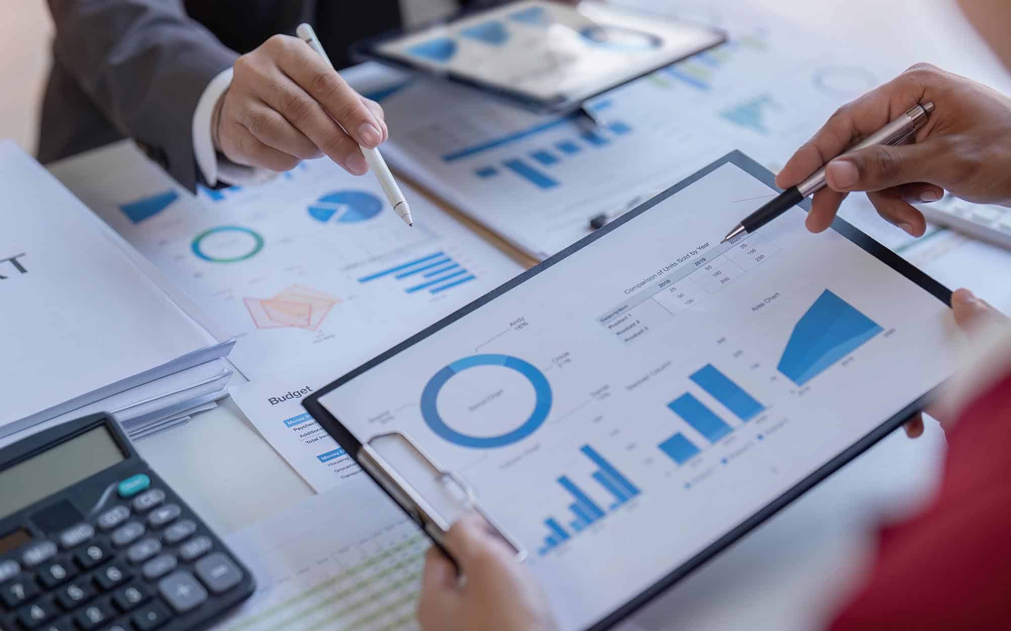 Image of two business people discussing business costs