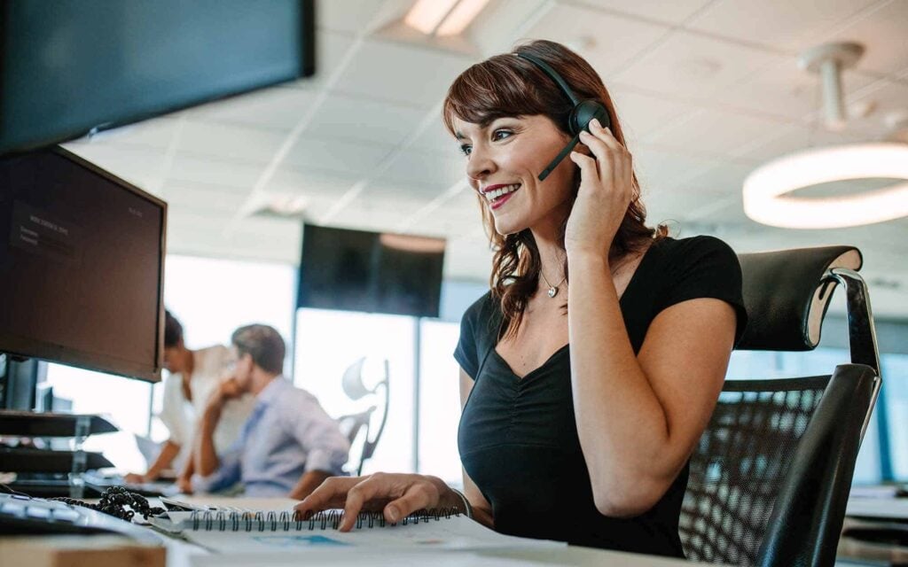 Woman working in call center smilling