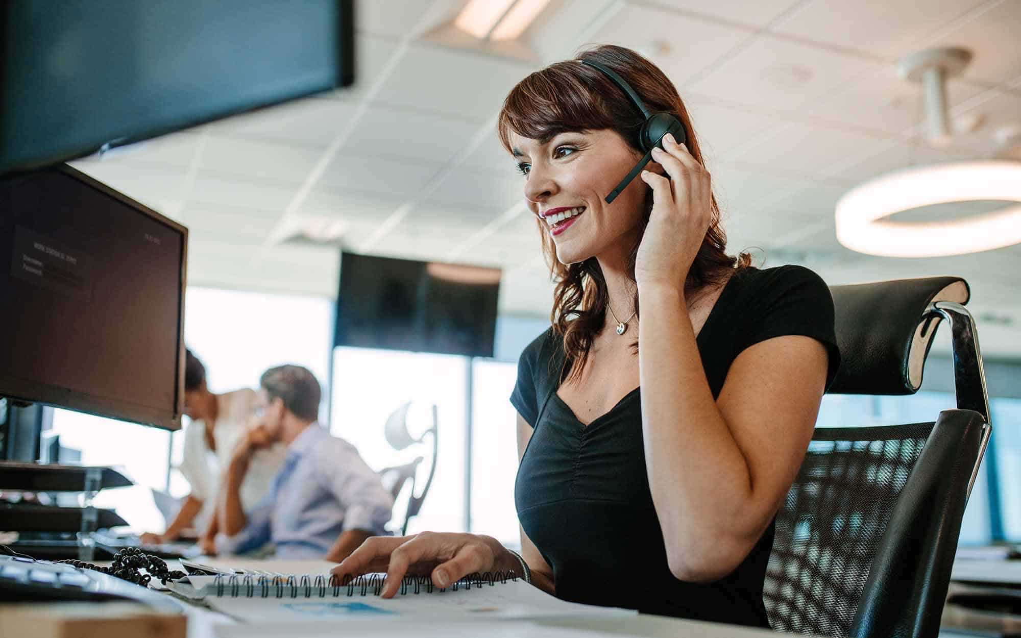 Woman working in call center smilling