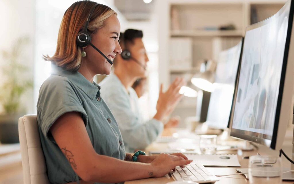 Side view of customer service representative smiling at her computer