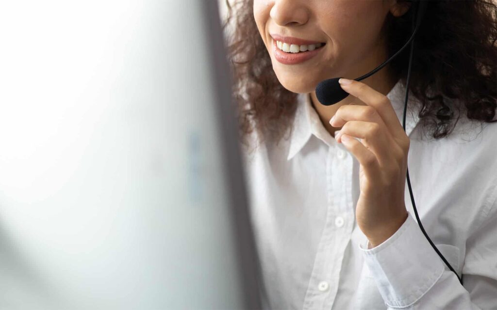 Side view of a woman with headset on talking into microphone