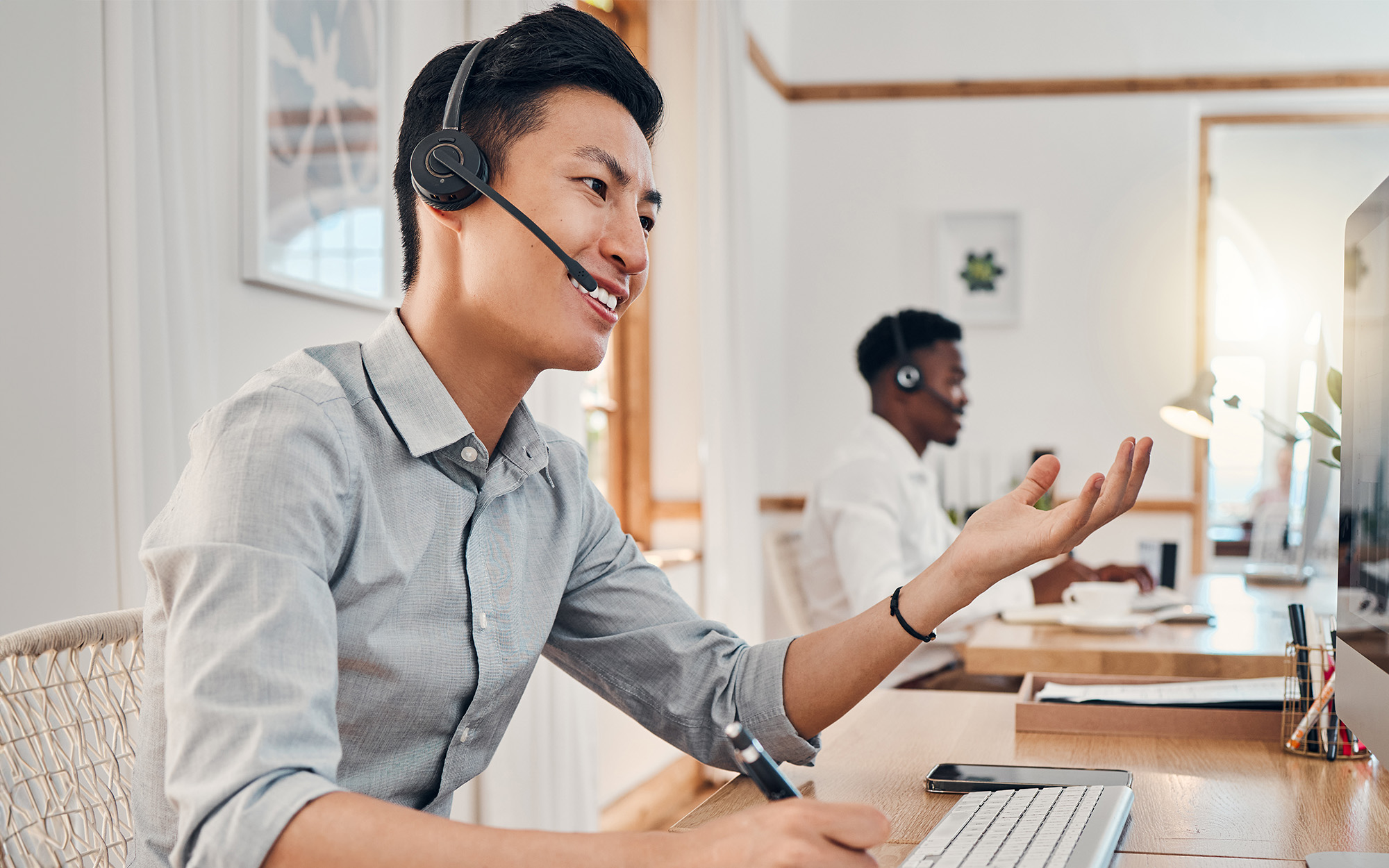 Consulting, call center and help with businessman at computer talking on phone call for customer support
