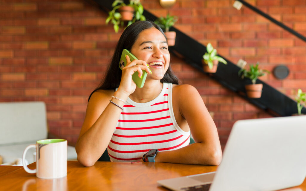 A happy customer talks on her phone to a fantastic call center agent