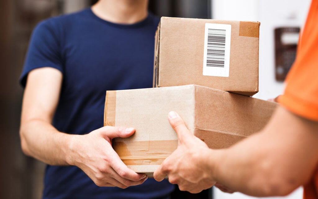 Person holding 2 delivery packages